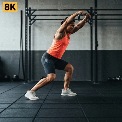 Person performing a kettlebell swing with proper form, illustrating dynamic movement and strength building